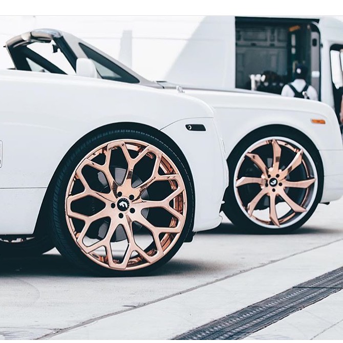 Close-up of custom wheels on a white Rolls-Royce.