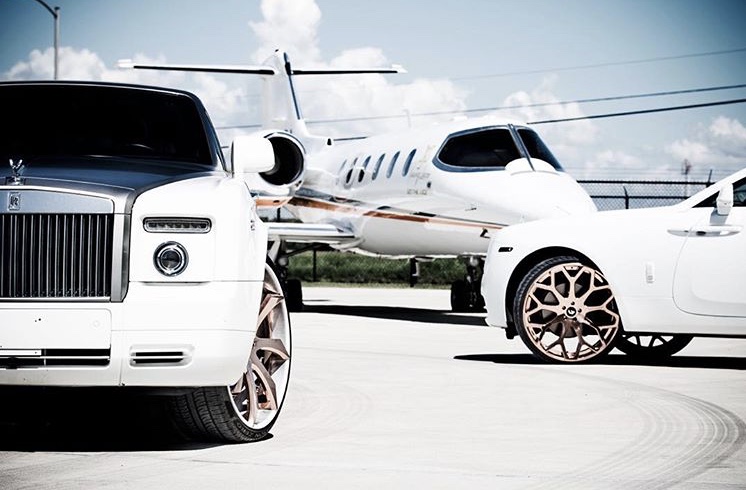 Rolls-Royce vehicles photographed alongside an aircraft.