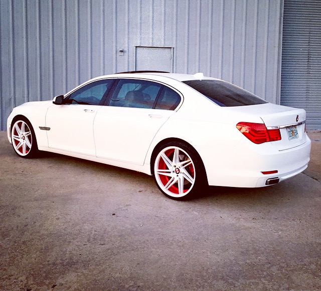 White BMW sedan with custom wheels.