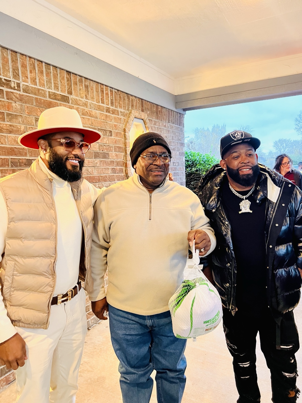 Three attendees together at a community turkey distribution gathering