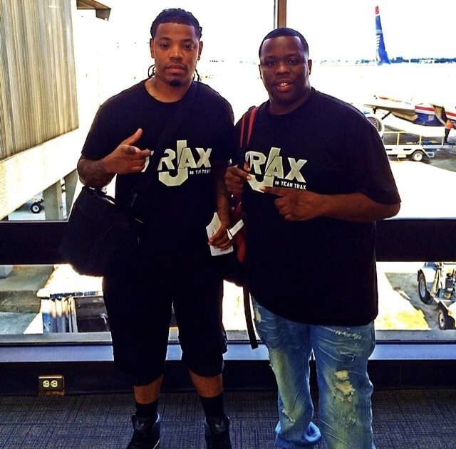 Music-industry collaborators wearing Team Trax shirts at an airport