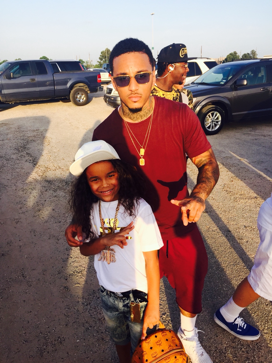 Young Lace in casual clothing standing with a young family member