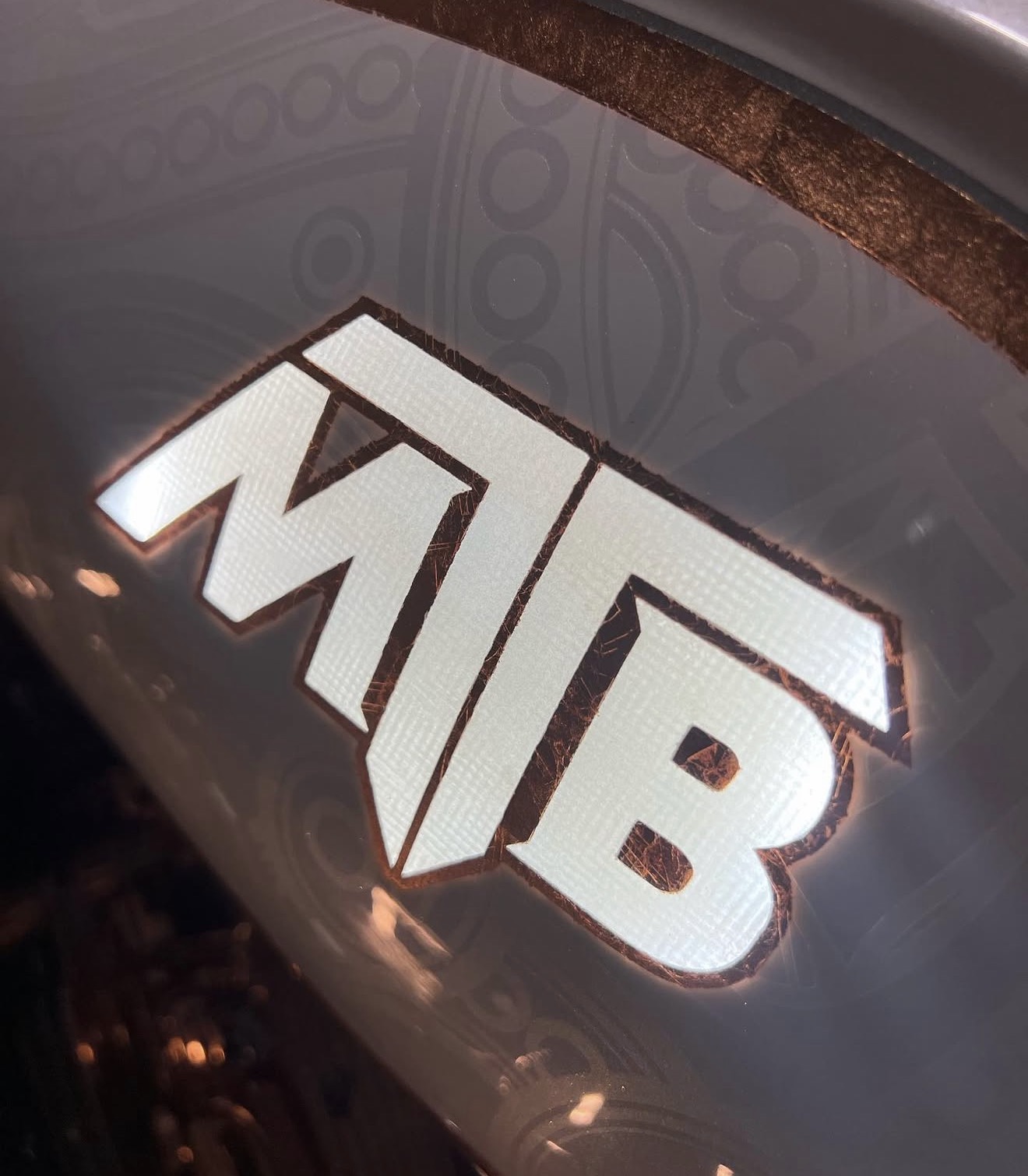 Illuminated MTB branding embedded in pearl paint