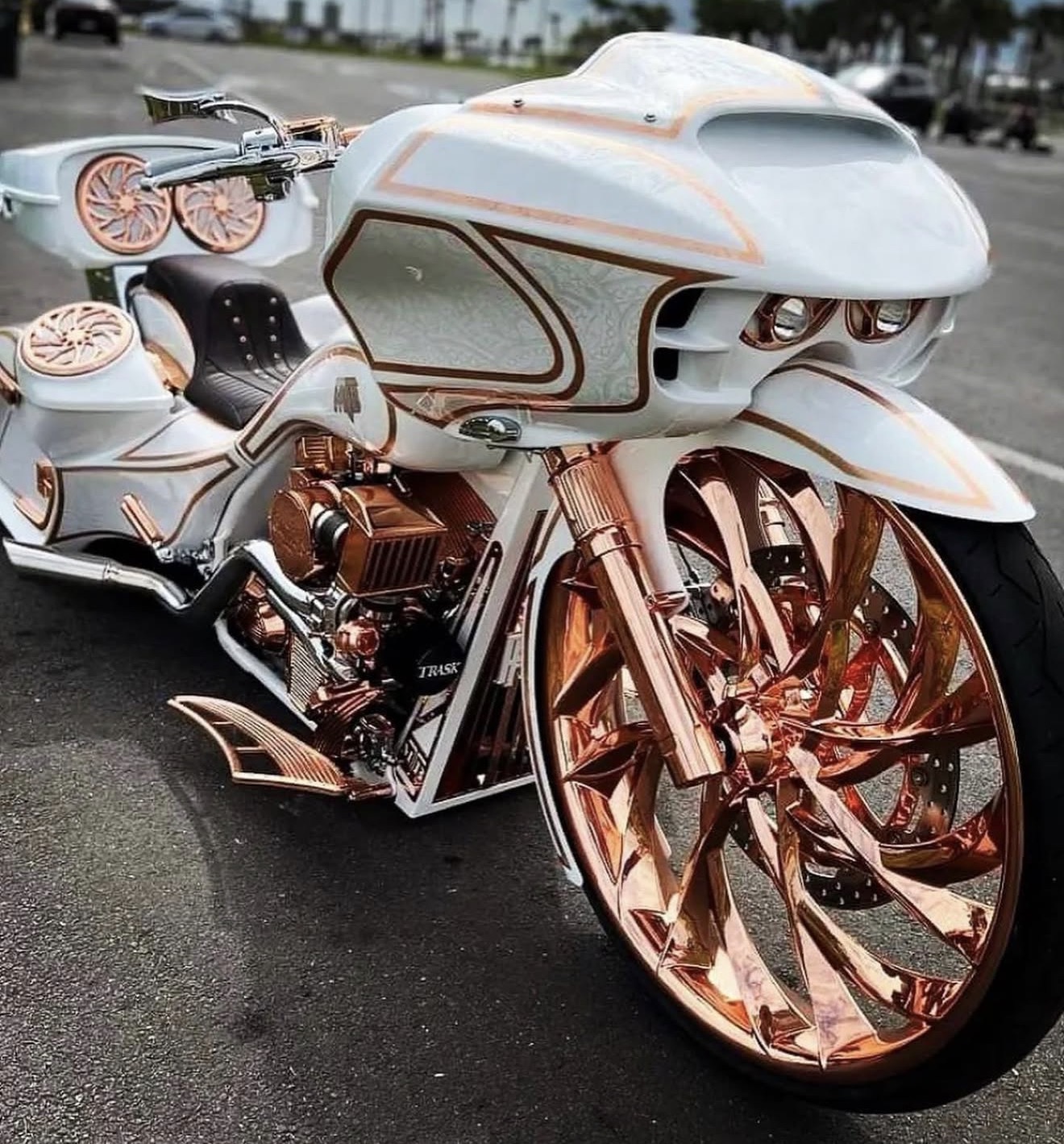 Close-up of the oversize rose-gold motorcycle front wheel